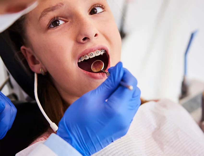 Orthodontist checking patients braces