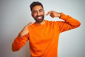 Male men showing his teeth after cosmetic treatment