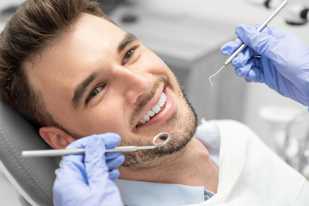 Male with great teeth getting regular dental cleaning