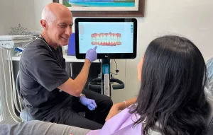 Expert dentist in San Juan Capistrano showing patient her treatment plan