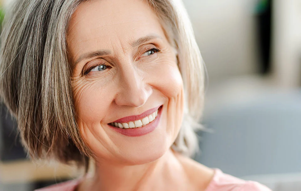 Senior female with dental implants smiling